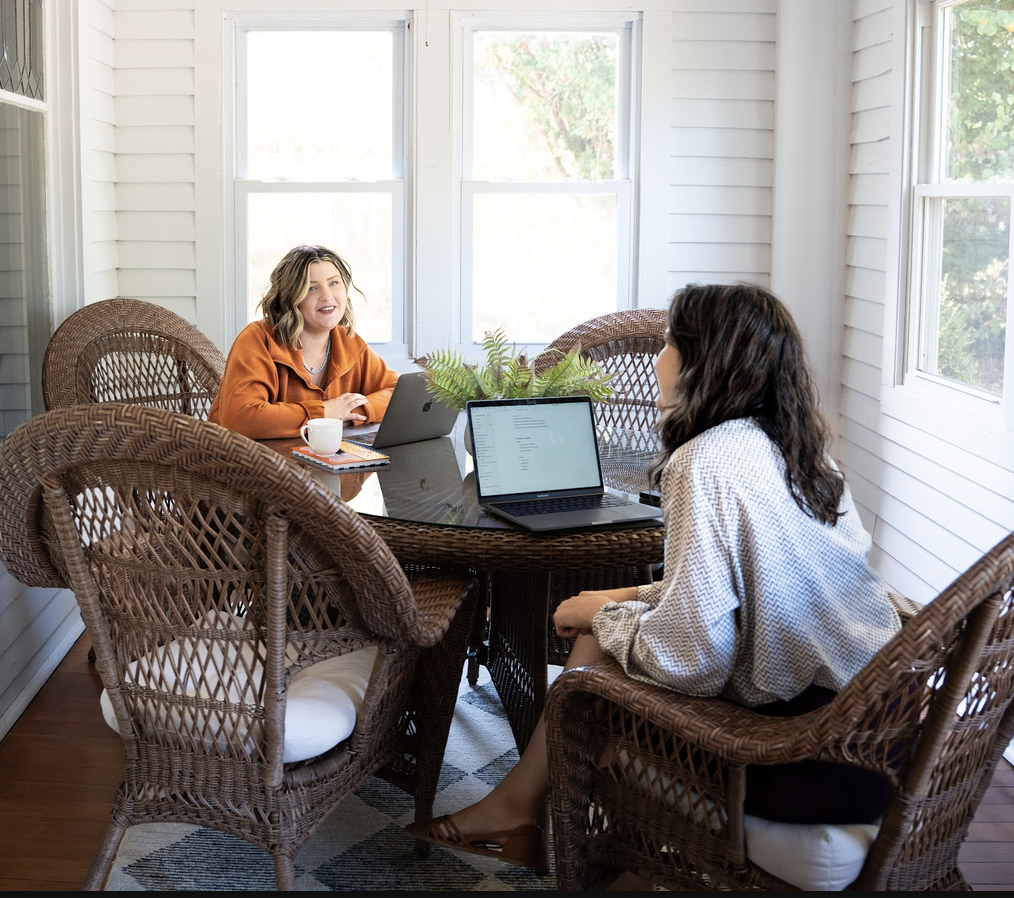2 women working on laptops together